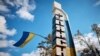 UKRAINE – A Ukrainian national flag flies on an entrance to the town of Kupiansk, liberated by the Ukrainian Armed Forces, amid Russia's attack on Ukraine, in Kharkiv region, September 19, 2022