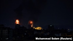 Explosions light up the sky after the Israeli military said in a statement that it has struck Islamic Jihad targets, in Gaza