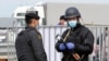 Kazakhstan - Kazakh law enforcement officers wearing protective masks stand guard at a checkpoint set up to lock down the city to prevent the spread of coronavirus disease (COVID-19), on the outskirts of Almaty, Kazakhstan March 24, 2020. REUTERS/Pavel Mi