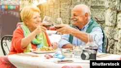 Happy pensioners drink wine in Italy