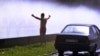 Belarus -- The young man refresh himself and his car in a cloud of spray from the fountain