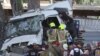 Israeli police and emergency responders recover the body of the truck driver at the site of a ramming attack in Ramat Hasharon, north of Tel Aviv on October 27, 2024.