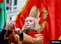 Жанчына робіць сэлфі на плошчы незалежнасьці ў Менску падчас сьвяткаваньняў гадавіны кастрычніцкага перавароту, 7 лістапада 2017 году