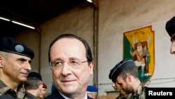 Central African Republic -- French President Francois Hollande speaks and greets troops at the French military base in Bangui's Mpoko international airport February 28, 2014.